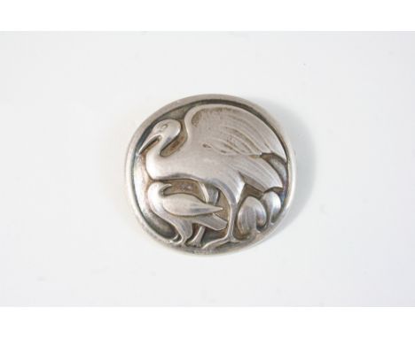 A SILVER BROOCH BY GEORG JENSEN circular, depicting two birds in a landscape, with maker's mark to the reverse and numbered 1