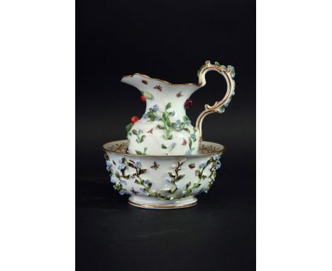 A COALBROOKDALE EWER AND BASIN delicately applied with forget-me-nots, blue cross swords mark and purple WT, basin 6 1/2ins. 
