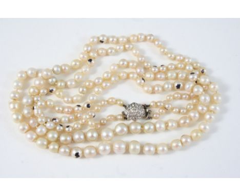 A DOUBLE ROW GRADUATED PEARL NECKLACE the one hundred and seventy pearls graduate from 3.7mm. to 7.7mm. to a diamond cluster 