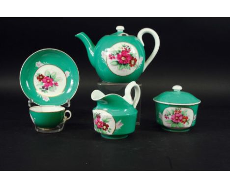 A GARDNER MOSCOW PART TEA SERVICE each piece painted with a bold floral spray, reserved on a green ground, comprising; teapot