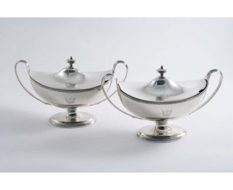 A PAIR OF GEORGE III BOAT-SHAPED SAUCE TUREENS & COVERS with reeded borders, pedestal bases & twin, loop handles, crested, by