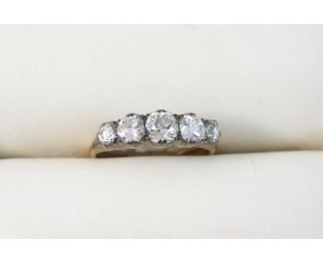 A VICTORIAN DIAMOND FIVE STONE RING set with five graduated old brilliant-cut diamonds, in silver and gold. Size R.