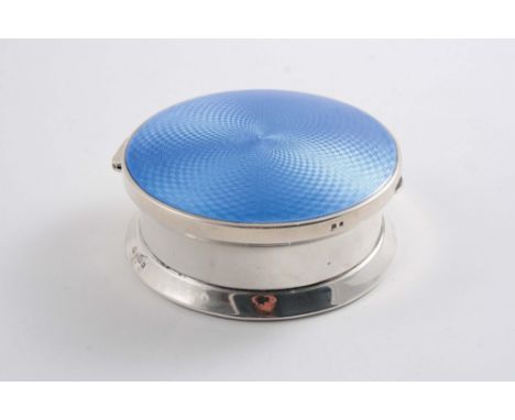 AN ART DECO CIRCULAR DRESSING TABLE BOX the cover enamelled in light blue over an engine-turned ground (loaded base), by Adie