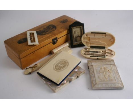 TWO VICTORIAN MOTHER OF PEARL CARD CASES one carved in relief with a courting couple, a Victorian ivory etui with silver gilt