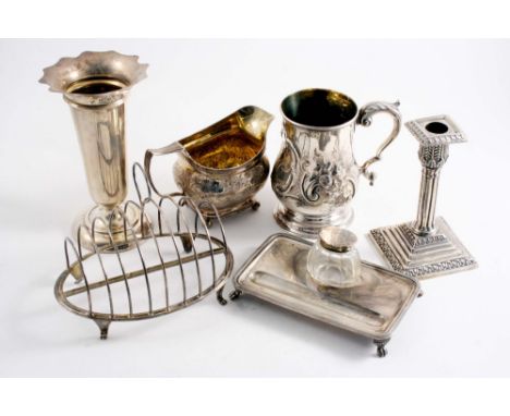 A MIXED LOT: A Victorian embossed mug, gilt interior, a George III cream jug, a single candlestick, a vase, a George III toas