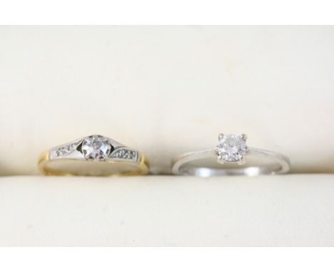 A DIAMOND SOLITAIRE RING set with a circular-cut diamond, in 18ct. white gold, size K, together with a diamond solitaire ring