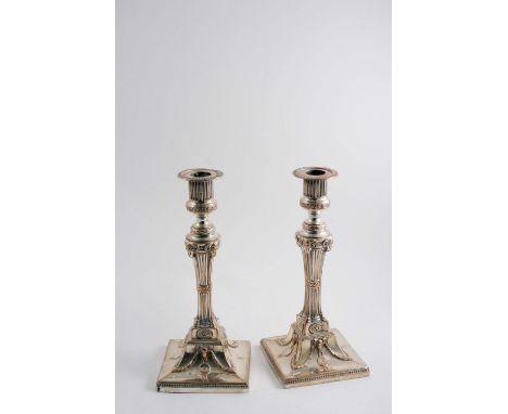 A PAIR OF EARLY PERIOD, OLD SHEFFIELD PLATED CANDLESTICKS in the Neo-Classical style on square bases decorated with rams' mas