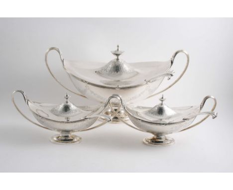 AN EDWARDIAN SUITE: A soup tureeen & cover and two sauce tureens & covers, boat-shaped with twin, reeded loop handles & oval 