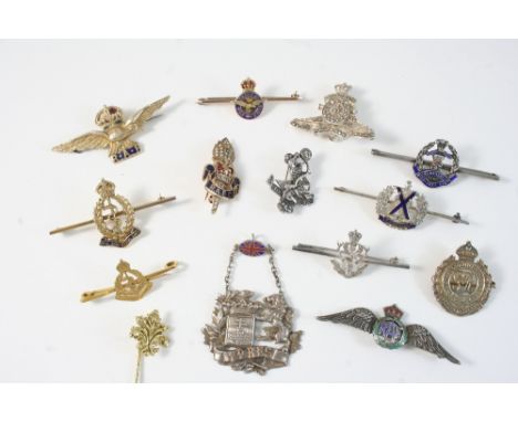 A QUANTITY OF GOLD AND ENAMEL REGIMENTAL BROOCHES together with various silver regimental brooches.