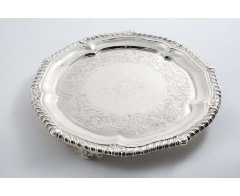 BY PAUL STORR: A small George III salver with a shaped gadrooned border, flat chasing & a central engraved crest, resting on 