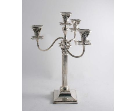 A VICTORIAN FOUR-LIGHT CANDELABRUM with a fluted column & a bevelled square base, crested, by R. Martin & E.Hall, London 1886