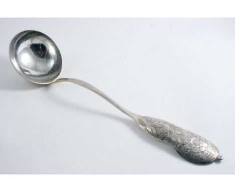 A LARGE 19TH CENTURY SOUTH AMERICAN LADLE  with a circular bowl & a florally chased upper stem, unmarked;  16.75"  (42.5 cms)
