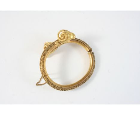 A VICTORIAN GOLD RAM'S HEAD HALF HINGED BANGLE with gold cannetille decoration, 36 grams, damaged hinge.