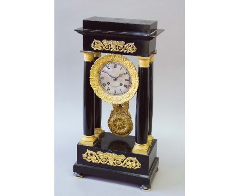 AN ORMOLU MOUNTED EBONISED PORTICO CLOCK dial "watered silk" silvered, movement drum striking on a bell, case applied with or