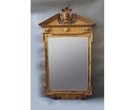 GEORGE II GILTWOOD LOOKING GLASS of architectural form with bevelled rectangular plate, set in a frame with outset corners, t