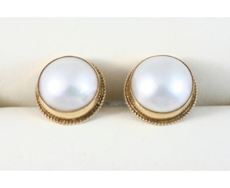 A PAIR OF CULTURED PEARL STUD EARRINGS each set in 9ct. gold.