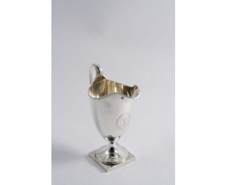 A GEORGE III HELMET CREAM JUG on a square pedestal foot with reeded borders, crested, by Henry Chawner, London 1789;  6.3"  (