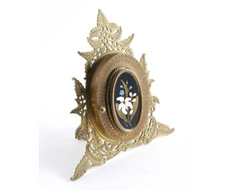 A VICTORIAN ENGRAVED  BRASS DIPTYCH FRAME with pierced decoration, an easel stand and an oval pietra dura panel on the front,