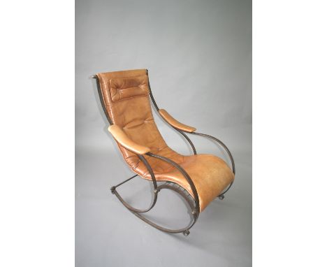 LATE VICTORIAN 'WINFIELD' ROCKING CHAIR a steel framed rocking chair with a slatted wooden seat and leather upholstery. In th