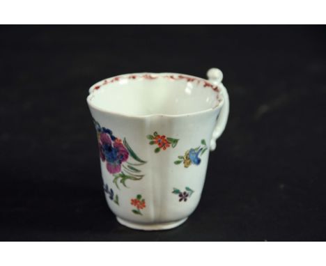 A FIRST PERIOD WORCESTER POLYCHROME COFFEE CUP of quatrefoil section, painted with scattered floral sprigs