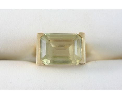 A CITRINE SINGLE STONE RING set with a rectangular-shaped citrine, in gold. Size K.