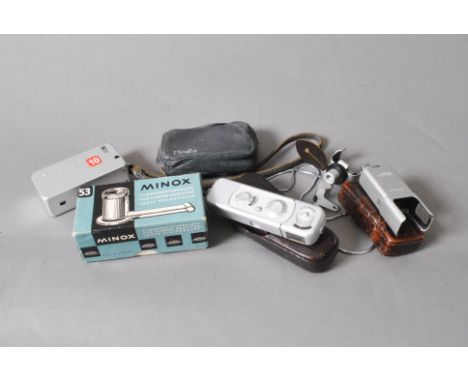 A Minox Spy Camera, flash cube adaptor both in leather cases, boxed Minox film viewing magnifier and a Minolta 16 camera