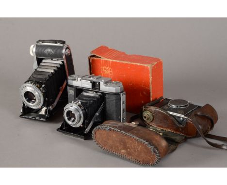 Three German Folding Cameras, an Agfa Record III 6 x 9cm uncoupled rangefinder camera with an Apotar 105mm f/4.5 lens, a Zeis