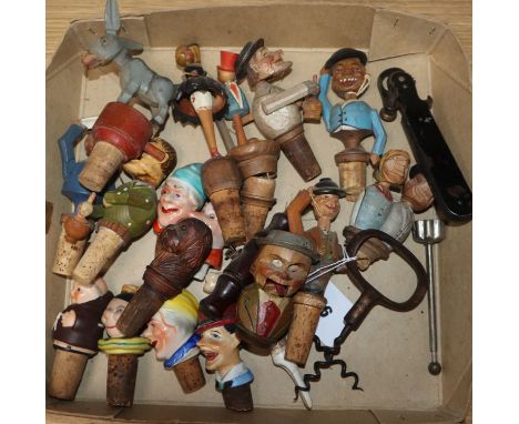 A collection of mixed ceramic and wooden bottle stoppers, two corkscrews etc