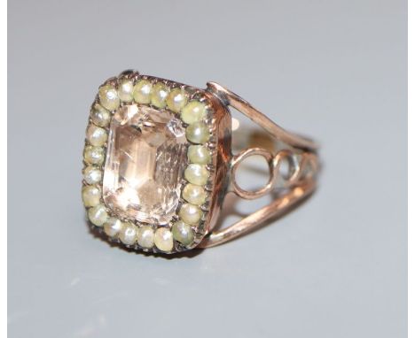 A Georgian yellow metal pink paste and seed pearl set ring, size I/J.