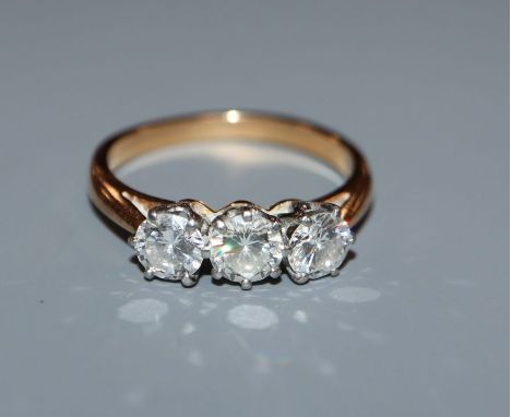 A diamond three-stone ring in yellow metal setting (tests as 18ct) size K.