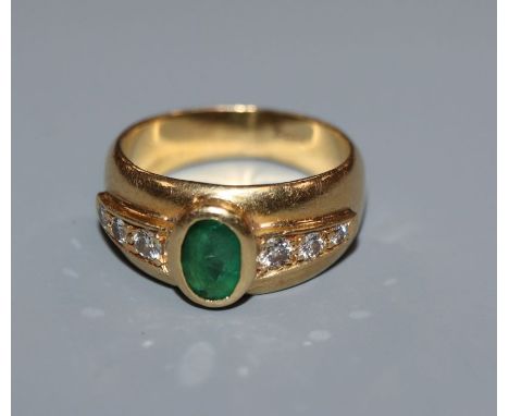 A moder 750 yellow metal, emerald and diamond set dress ring, size J/K