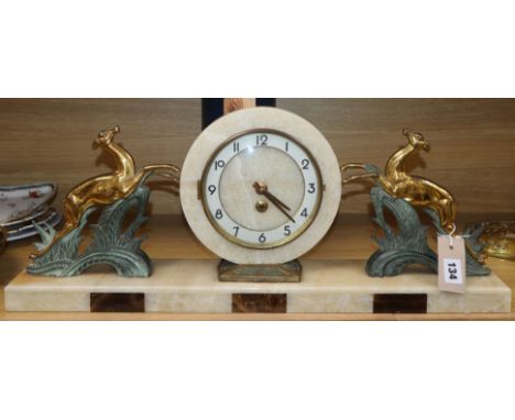 An Art Deco style onyx, marble and spelter mantel clock length 64cm