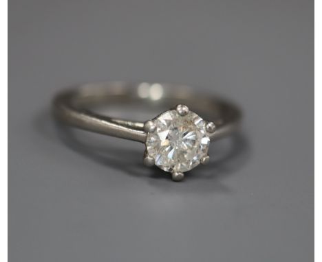 A modern platinum and solitaire diamond ring, the stone weighing approximately 0.66cts, size I.