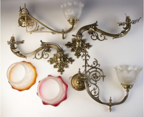 A pair of Victorian brass wall sconces, each converted to electricity, the quatrefoil fleur-de-lys backplates each supporting