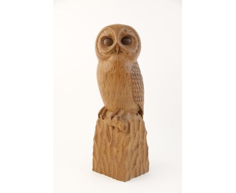 Workshop of Robert 'Mouseman' Thompson of Kilburn, a carved oak model of an owl, modelled standing on a rocky outcrop, grippi