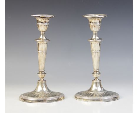 A pair of late Victorian silver candlesticks, Harrison Brothers &amp; Howson, Sheffield 1899, each with tapering knopped stem