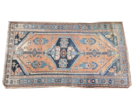A Anatolia Yahyali type rug, woven in blue and red dyes with a central amulet within an open field, 195cm x 106cmCondition re