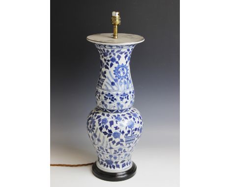 A Chinese porcelain blue and white lamp base, 20th century, the baluster shaped vase with flared neck, decorated with scrolli