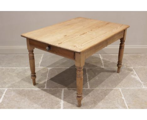 A Victorian pine kitchen table, the rectangular top with rounded corners above a single frieze drawer, raised upon ring turne