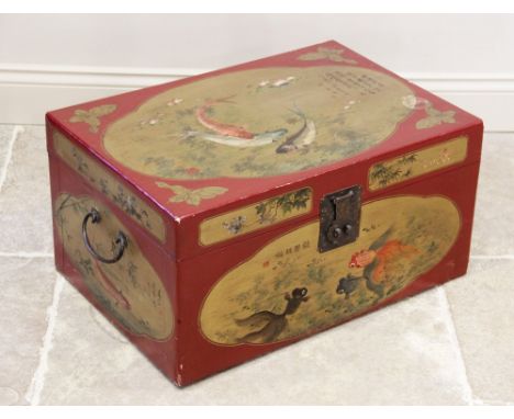 A Chinese red lacquer trunk, early 20th century, of rectangular hinged form, applied with gilt quatreform panels depicting ca