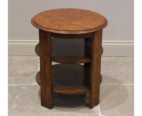 A 1930's Art Deco golden oak occasional table, the circular moulded top raised upon four plain supports, united by two circul