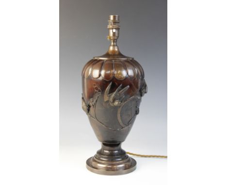 A Japanese bronze lamp base, Meiji period (1868-1912), of baluster form and relief decorated with birds perched upon branches