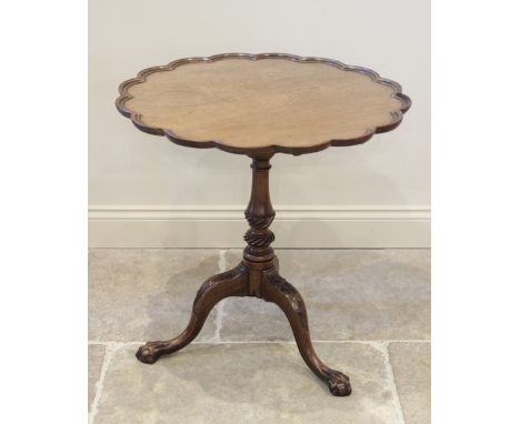 A George III mahogany tray top tripod table, the scalloped table top mounted upon a birdcage movement and a baluster pillar, 