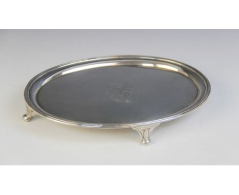 A George III silver teapot stand, marked ?IT? (possibly John Tatum I), London 1790, of oval form with reeded border raised on