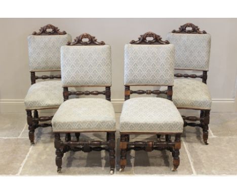 A set of six oak 17th century revival dining chairs, late 19th century, each with a 'C' scroll leaf carved aperture above a p