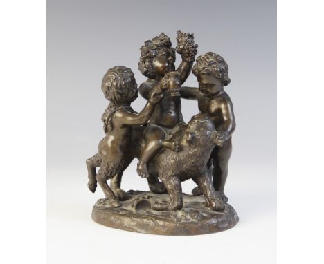 A bronze figural group, 19th century, modelled as a young Bacchus or Dionysis riding a lion accompanied by a fawn and a putti