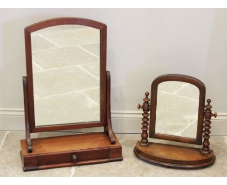 A Victorian mahogany dressing table mirror, the arched mirrored plate raised upon curved supports and a plinth base with sing