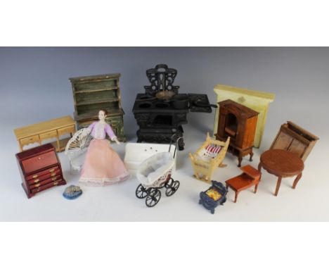 A selection of vintage dolls house furniture and accessories, to include; a cast iron range cooker, 10cm high, a wooden Welsh