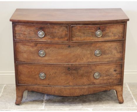 An early 19th century mahogany bow front chest of drawers, formed as two short over two long drawers applied with circular br