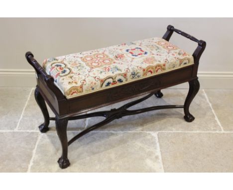 An Edwardian mahogany Chippendale revival duet piano stool, the hinged tapestry and upholstered top above a frieze centred wi